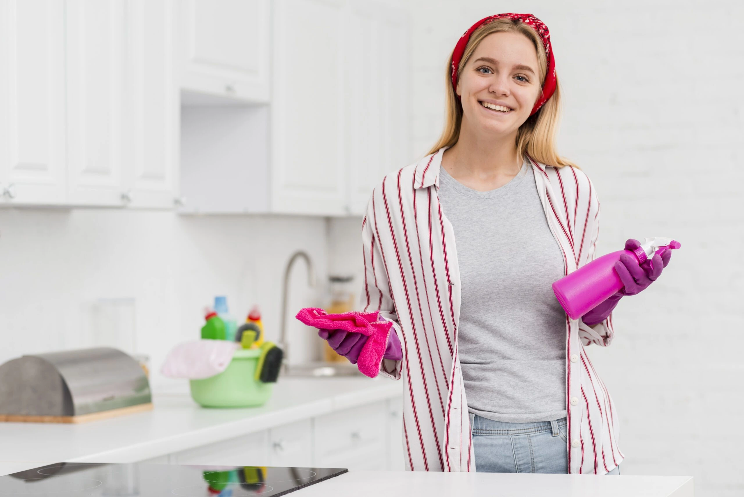Friendly cleaning professional from Maid in the Shade in client kitchen