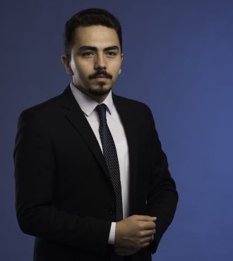 Businessman in black suit with a tie posing. High quality photo