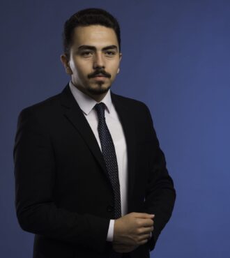 A white ceramic reed diffuser on a wooden table, adding a fresh scent to a professionally cleaned room
